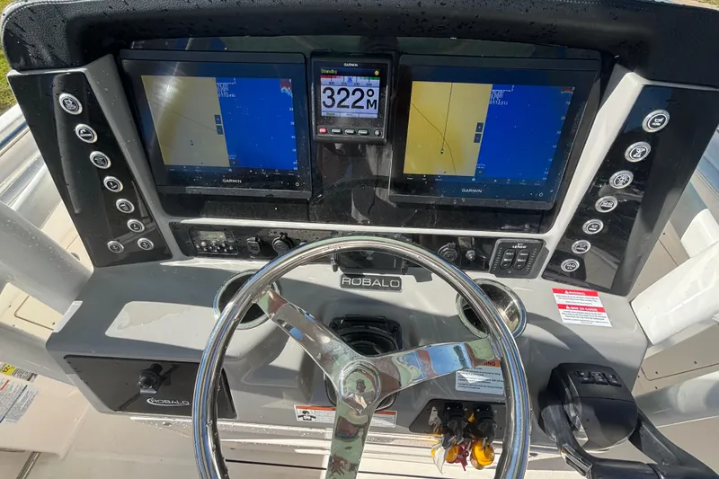 Slide: The Image of 2022 Robalo R242 Center Console dashboard with Garmin navigation displays and steering wheel. - 6