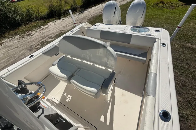 Slide: The Image of 2022 Robalo R242 Center Console boat interior with dual seats and steering wheel. - 7
