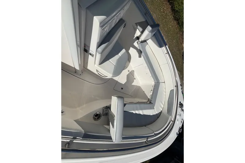 Slide: The Image of 2022 Robalo R242 Center Console boat interior with cushioned seating and storage compartments. - 8