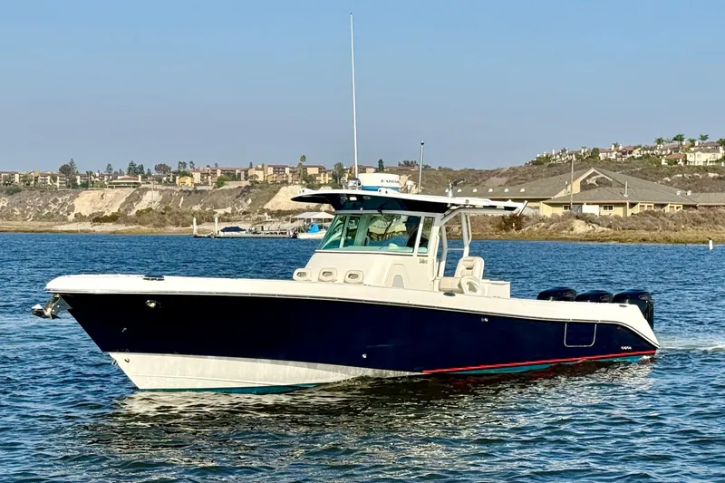 Slide: The Image of 2008 Everglades 350 Center Console boat cruising on a scenic waterway. - 0