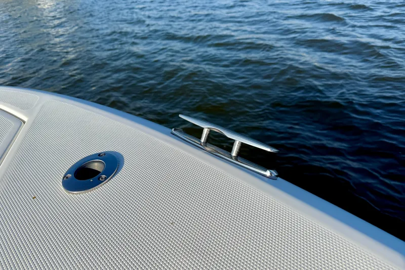 Slide: The Image of 2008 Everglades 350 Center Console boat detail with cleat and water view. - 13