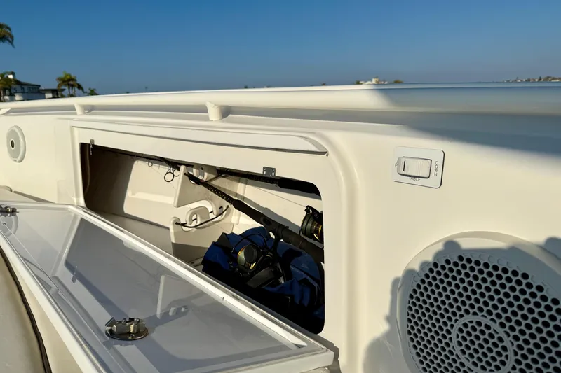 Slide: The Image of 2008 Everglades 350 Center Console boat with open storage compartment and fishing gear. - 15
