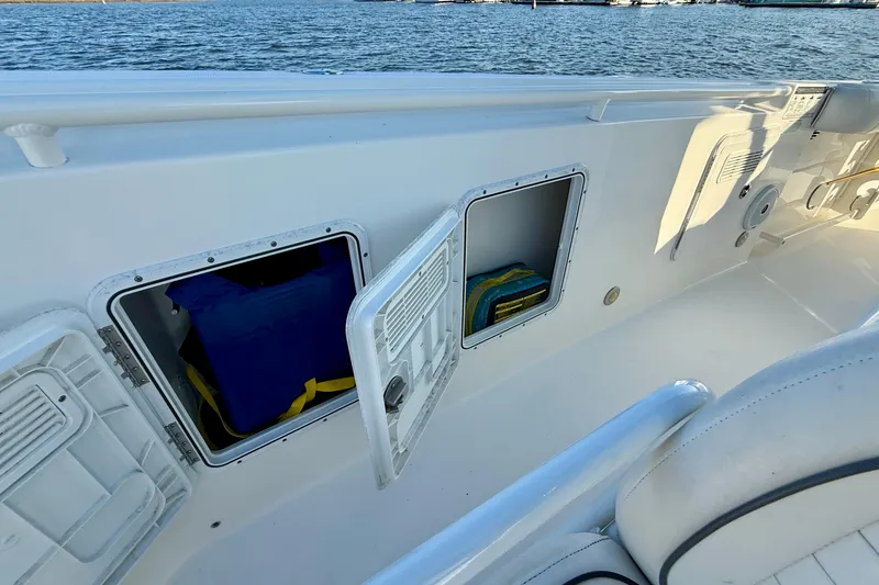 Slide: The Image of 2008 Everglades 350 Center Console boat with open storage compartments by the water. - 18