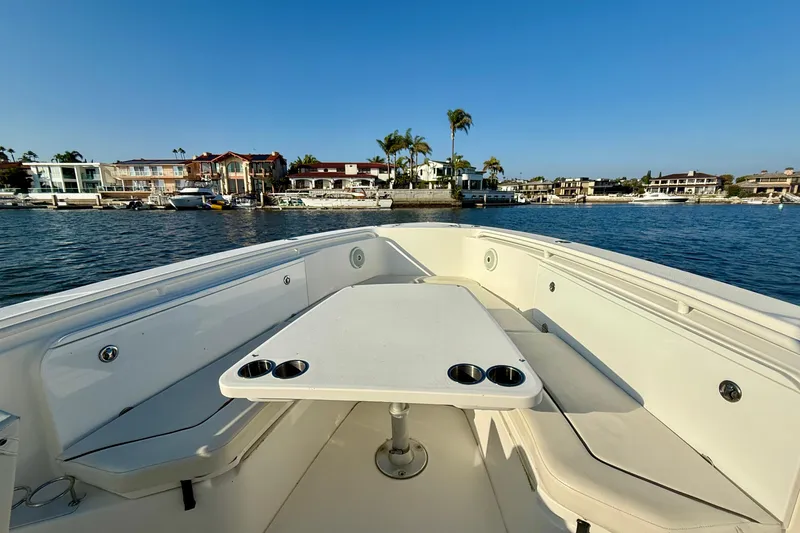 Slide: The Image of 2008 Everglades 350 Center Console boat with seating and table, docked near waterfront homes. - 20