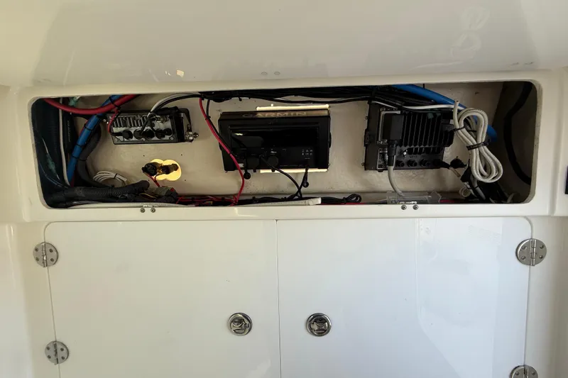 Slide: The Image of 2008 Everglades 350 Center Console electronics compartment with wiring and equipment. - 26
