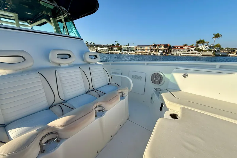 Slide: The Image of 2008 Everglades 350 Center Console boat interior with white seating, coastal view. - 27