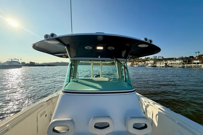 Slide: The Image of 2008 Everglades 350 Center Console boat on water, sunny day, coastal background. - 28