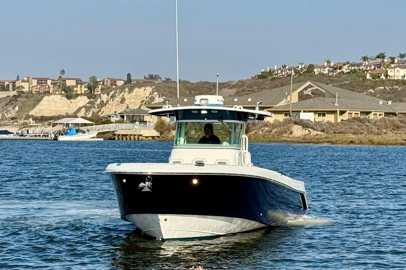 Slide: The Image of 2008 Everglades 350 Center Console boat cruising on a scenic waterway. - 3