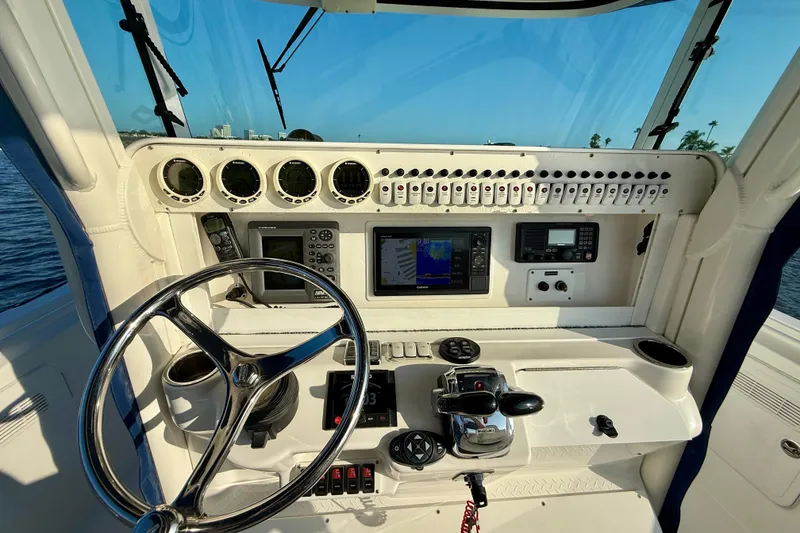 Slide: The Image of 2008 Everglades 350 Center Console boat dashboard with steering wheel and navigation instruments. - 30