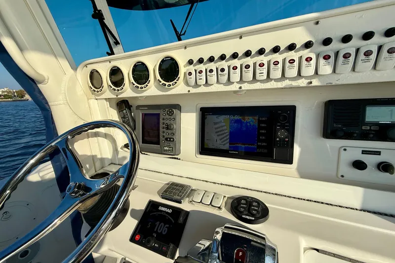 Slide: The Image of 2008 Everglades 350 Center Console boat dashboard with navigation and control systems. - 32