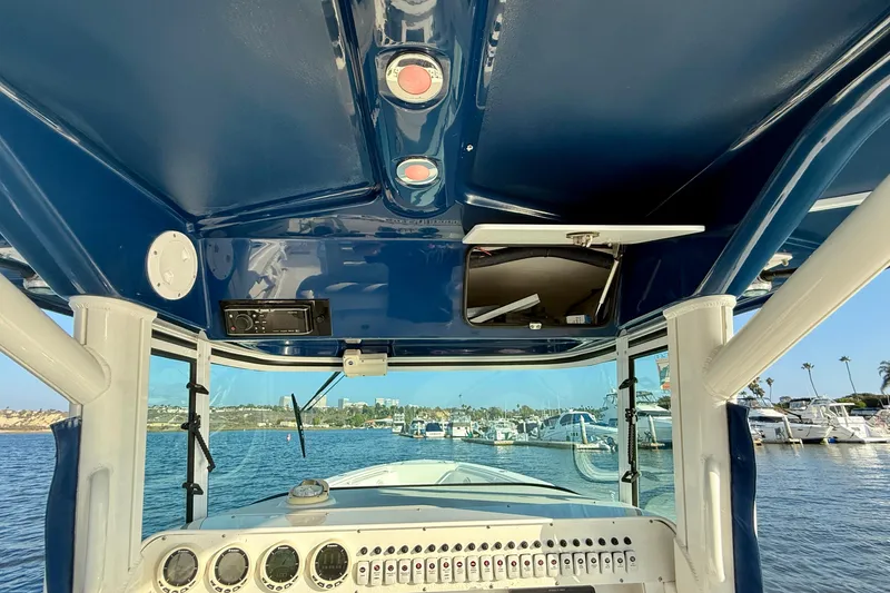 Slide: The Image of 2008 Everglades 350 Center Console boat interior with dashboard and marina view. - 34