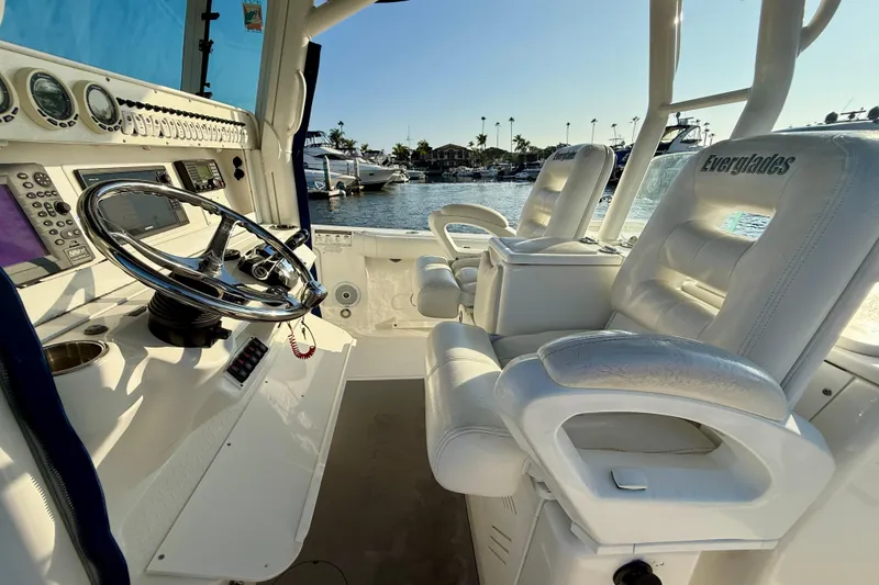 Slide: The Image of 2008 Everglades 350 Center Console boat interior with steering wheel and plush seating. - 35