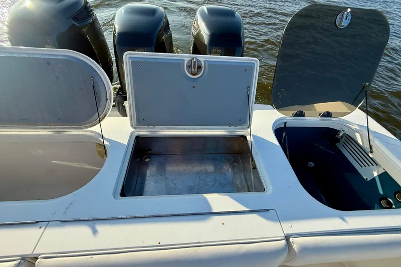 Slide: The Image of 2008 Everglades 350 Center Console boat with open storage compartments and visible outboard motors. - 38