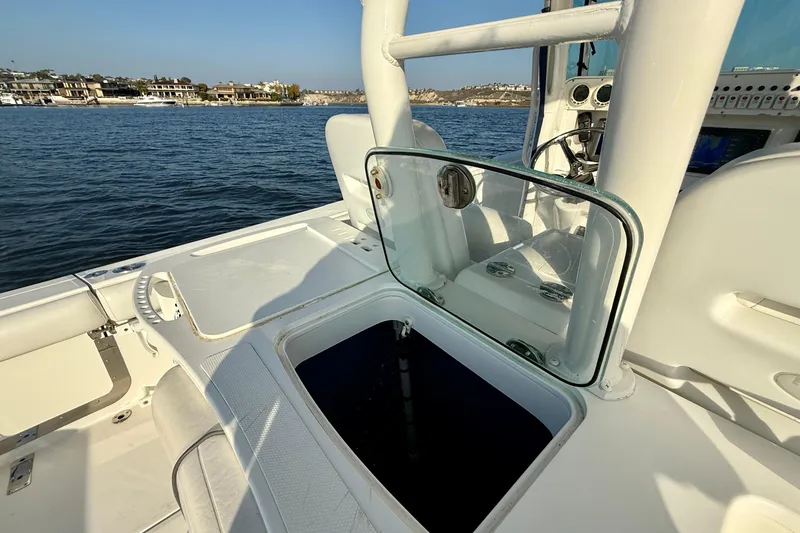 Slide: The Image of 2008 Everglades 350 Center Console boat interior with open hatch, on calm water. - 40