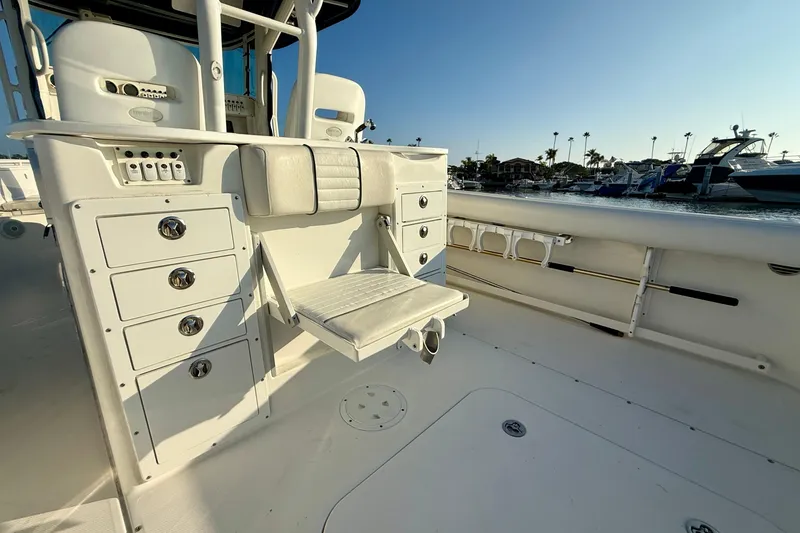 Slide: The Image of 2008 Everglades 350 Center Console boat interior with seating and storage, docked at marina. - 43
