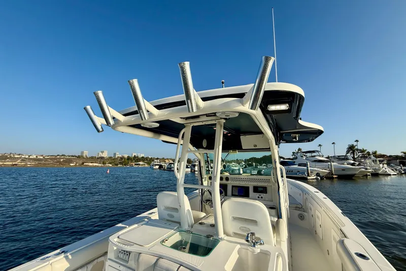 Slide: The Image of 2008 Everglades 350 Center Console boat on water, clear sky, marina background. - 47
