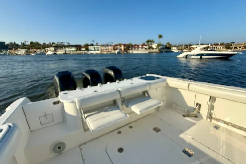 Slide: The Image of 2008 Everglades 350 Center Console boat on water, with scenic coastal background. - 48
