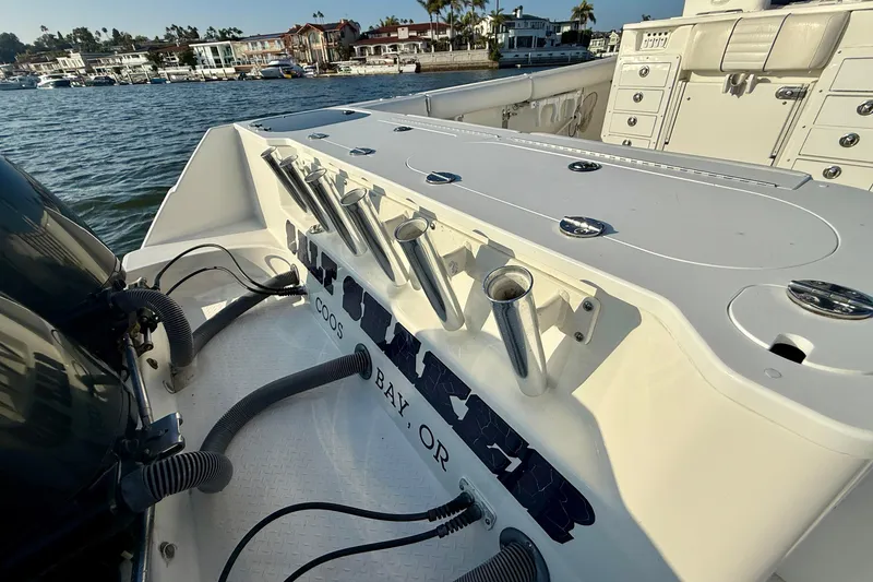 Slide: The Image of 2008 Everglades 350 Center Console boat with rod holders, docked near waterfront homes. - 54