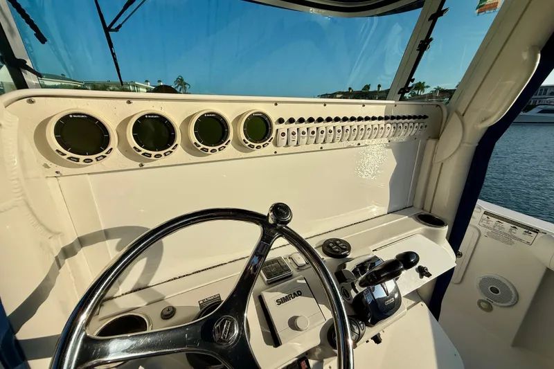 Slide: The Image of 2008 Everglades 350 Center Console boat dashboard with steering wheel and control panel. - 57