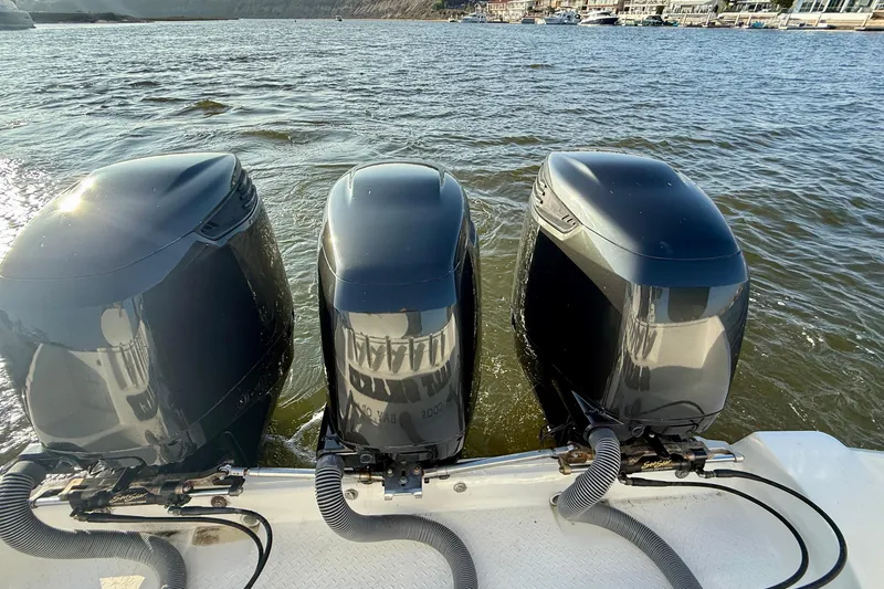 Slide: The Image of Triple outboard engines on a 2008 Everglades 350 Center Console boat in water. - 58