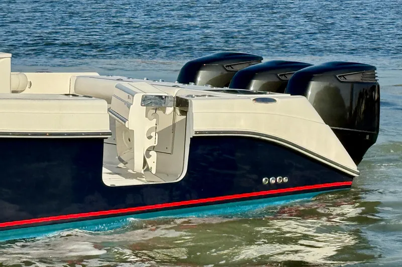 Slide: The Image of 2008 Everglades 350 Center Console boat with triple outboard motors on water. - 6