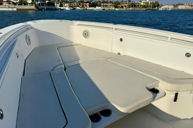 Slide: The Image of 2008 Everglades 350 Center Console boat with spacious seating, docked by waterfront homes. - 9