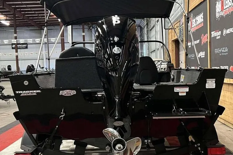 Slide: The Image of 2026 Tracker Pro Guide V-175 Combo boat in showroom, rear view with motor. - 6