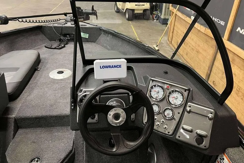 Slide: The Image of 2026 Tracker Pro Guide V-175 Combo boat interior with steering wheel and Lowrance electronics. - 7