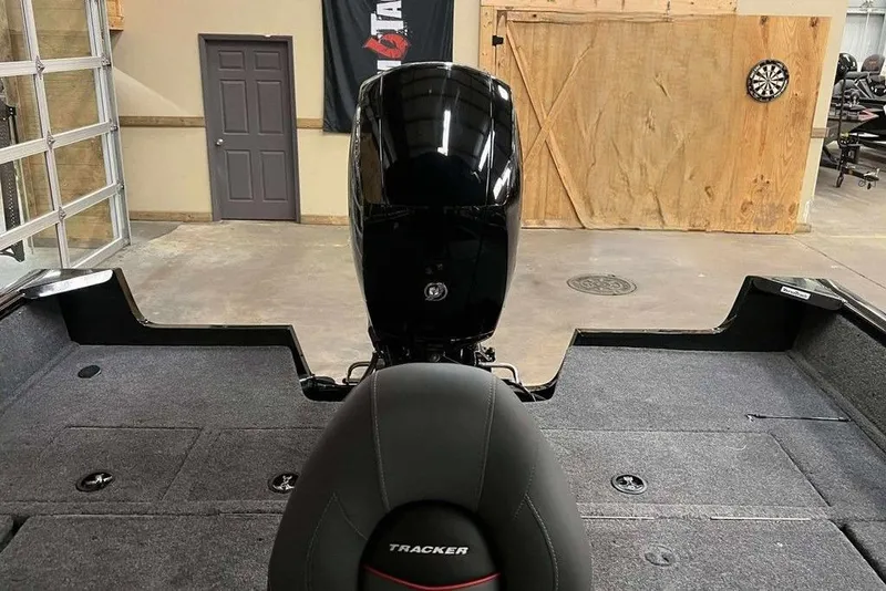 Slide: The Image of 2026 Tracker Pro Guide V-175 Combo boat interior with motor in a garage setting. - 9