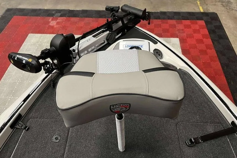 Slide: The Image of 2026 Triton 18 TrX boat interior with seat, trolling motor, and Lowrance electronics. - 9