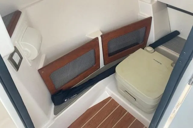 Slide: The Image of 2020 Grady-White Freedom 235 boat interior with portable toilet and storage compartments. - 10