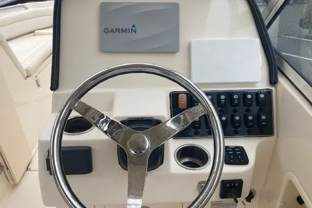 Slide: The Image of Steering wheel and controls of 2020 Grady-White Freedom 235 boat with Garmin navigation. - 14
