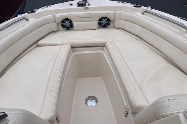 Slide: The Image of 2020 Grady-White Freedom 235 boat interior with cushioned seating and speakers. - 15
