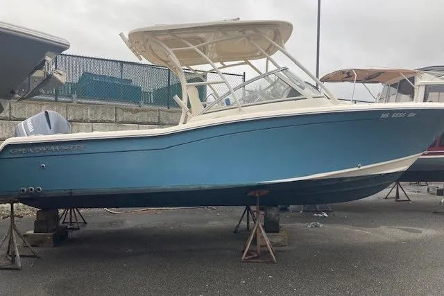 Slide: The Image of 2020 Grady-White Freedom 235 boat in storage, blue hull, on stands. - 4