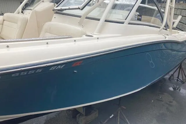 Slide: The Image of 2020 Grady-White Freedom 235 boat with blue hull and white interior. - 6