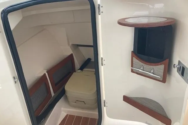Slide: The Image of 2020 Grady-White Freedom 235 boat interior with storage and seating area. - 9