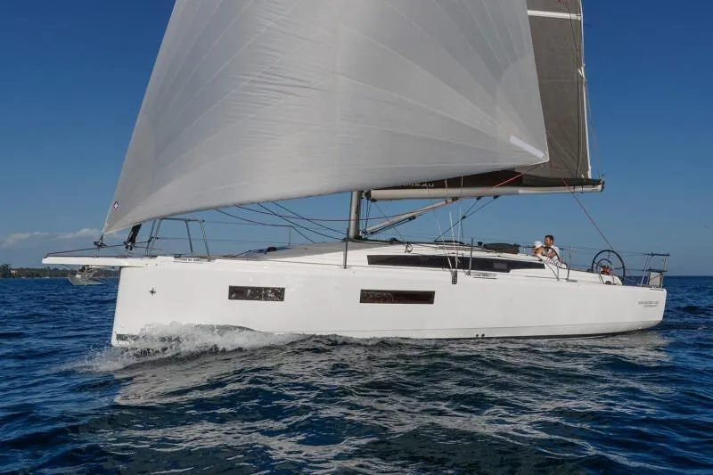 Slide: The Image of 2026 Jeanneau Sun Odyssey 350 sailing on open water under clear blue skies. - 15