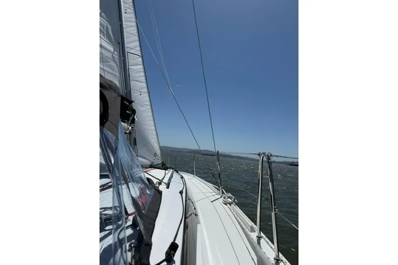 Slide: The Image of Sailing on a Jeanneau Sun Odyssey 350, 2026 model, under clear blue skies. - 4