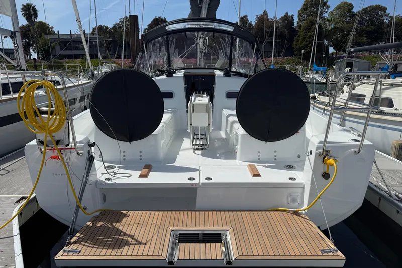 Slide: The Image of 2026 Jeanneau Sun Odyssey 350 sailboat docked, rear view with dual steering wheels. - 5