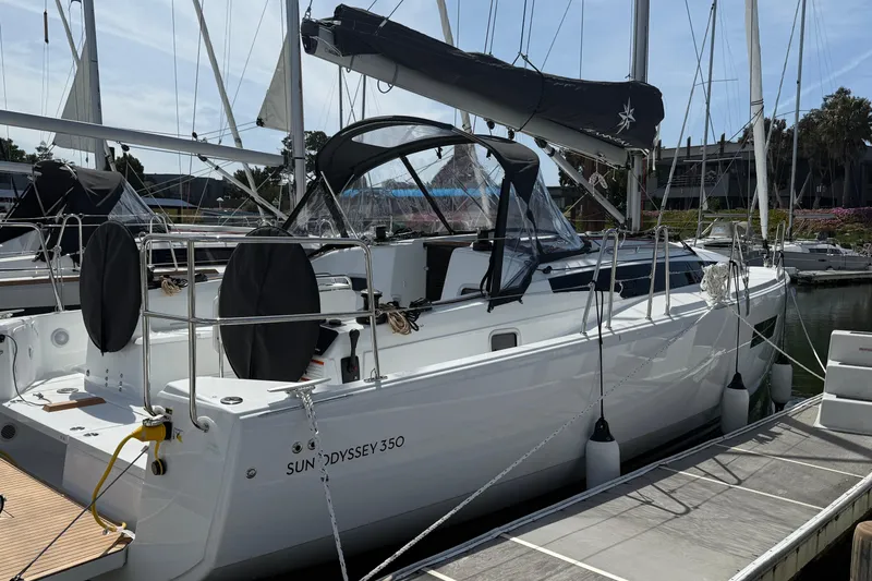 Slide: The Image of 2026 Jeanneau Sun Odyssey 350 sailboat docked at marina, featuring sleek design and modern amenities. - 6