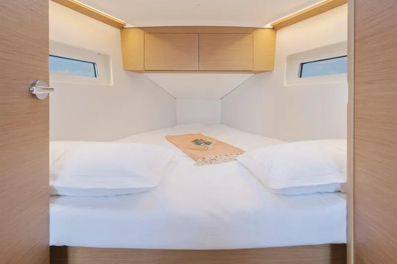 Slide: The Image of Cozy cabin interior of 2026 Jeanneau Sun Odyssey 350 sailboat with double bed. - 7