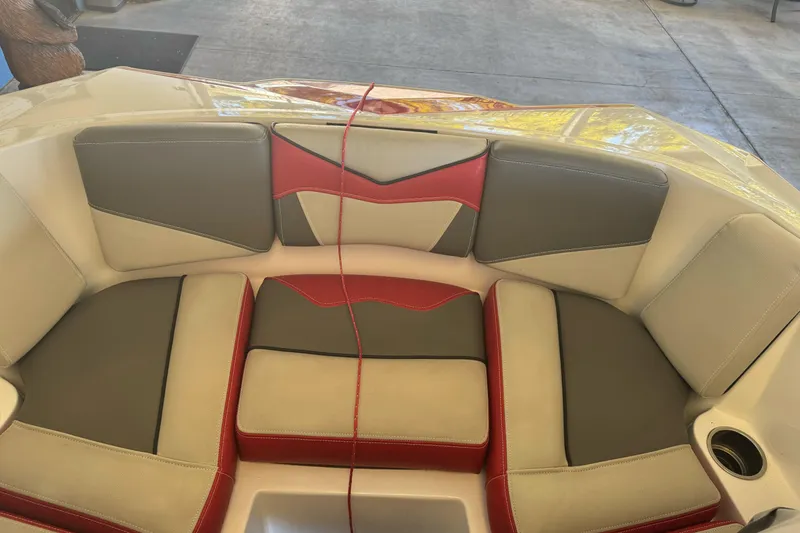 Slide: The Image of 2023 Supreme ZS212 boat interior with gray, red, and white cushioned seating. - 25