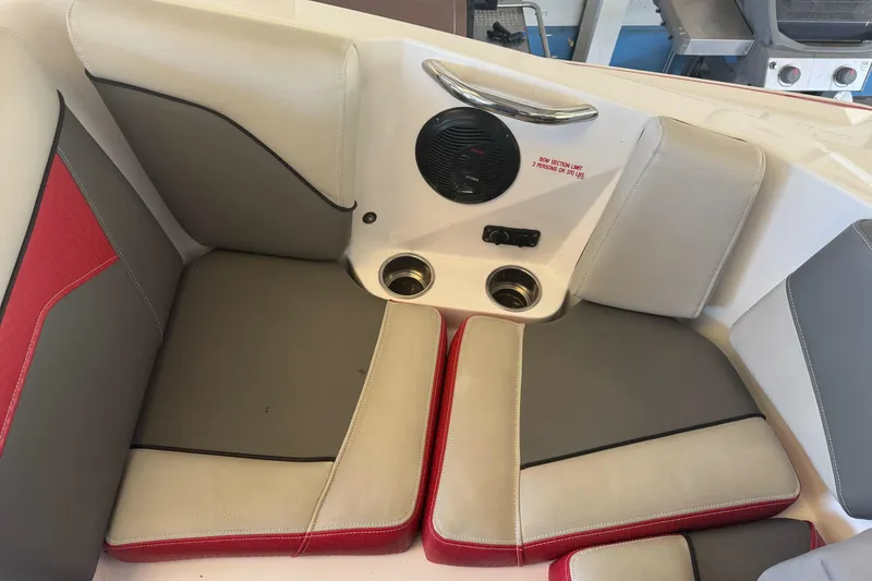 Slide: The Image of 2023 Supreme ZS212 boat interior with red and gray cushioned seating. - 26