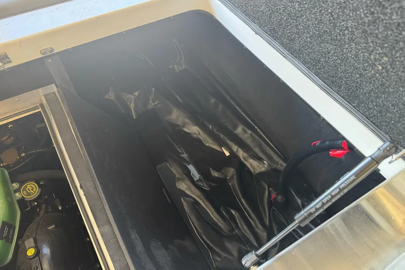 Slide: The Image of 2023 Supreme ZS212 storage compartment with red and gray seat, featuring yellow rope. - 30