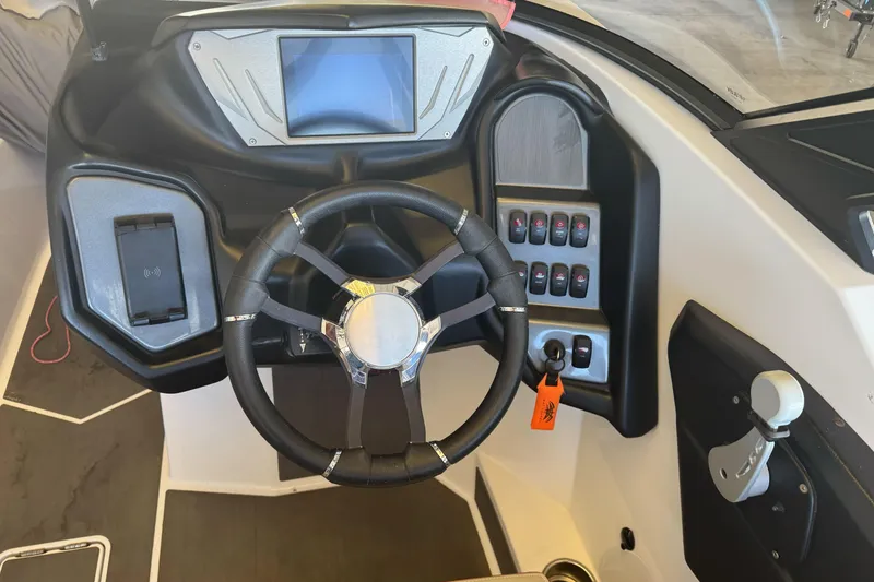 Slide: The Image of Trailer hitch of a 2023 Supreme ZS212 boat in a parking lot. - 7