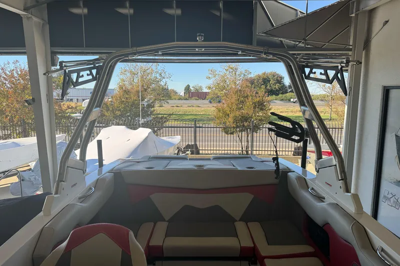 Slide: The Image of 2023 Supreme ZS212 boat interior with gray and red cushioned seating. - 9