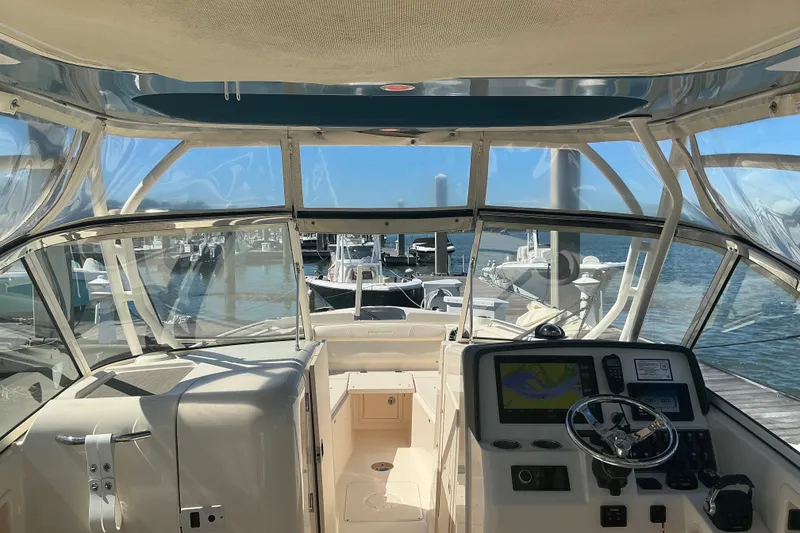 Slide: The Image of 2020 Grady-White Freedom 285 boat interior with navigation system, docked at marina. - 10