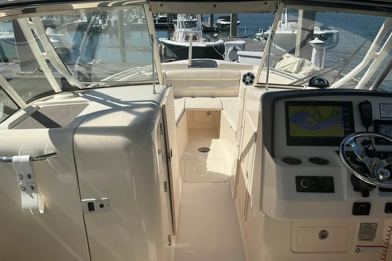 Slide: The Image of 2020 Grady-White Freedom 285 boat interior with navigation system and steering wheel. - 11