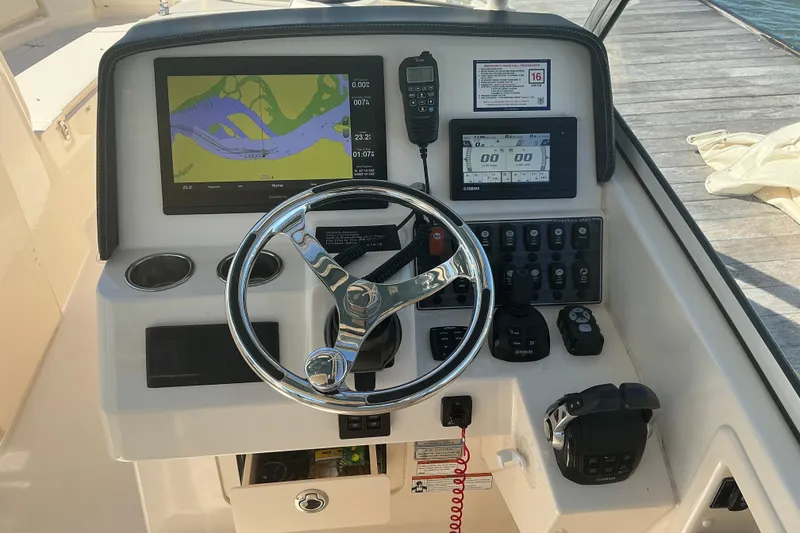 Slide: The Image of Helm of 2020 Grady-White Freedom 285 boat with navigation and control systems. - 13