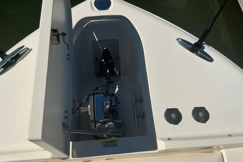 Slide: The Image of Anchor compartment of 2020 Grady-White Freedom 285 boat, open with visible anchor and fittings. - 14